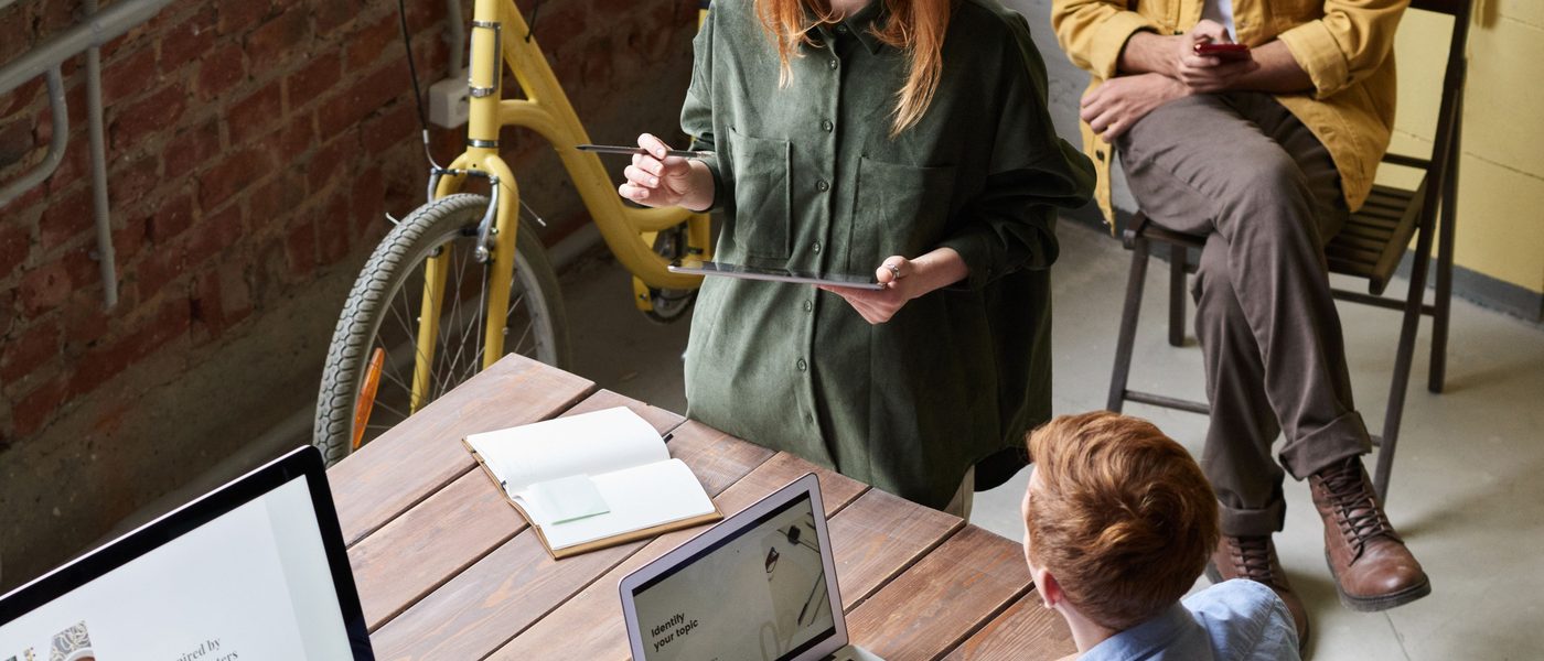 A team working together around a shared desk in a studio